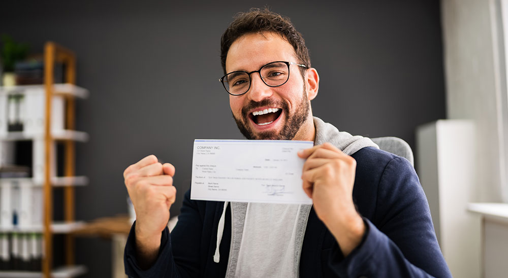 Man with payslip happy